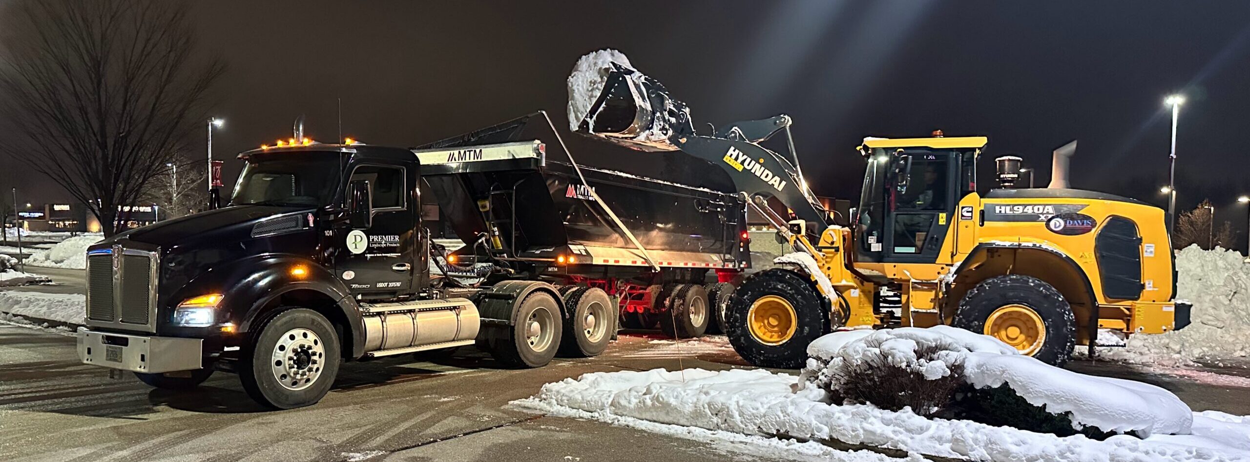 hyundai loader loading snow into international dump truck in west milwaukee wisconsin